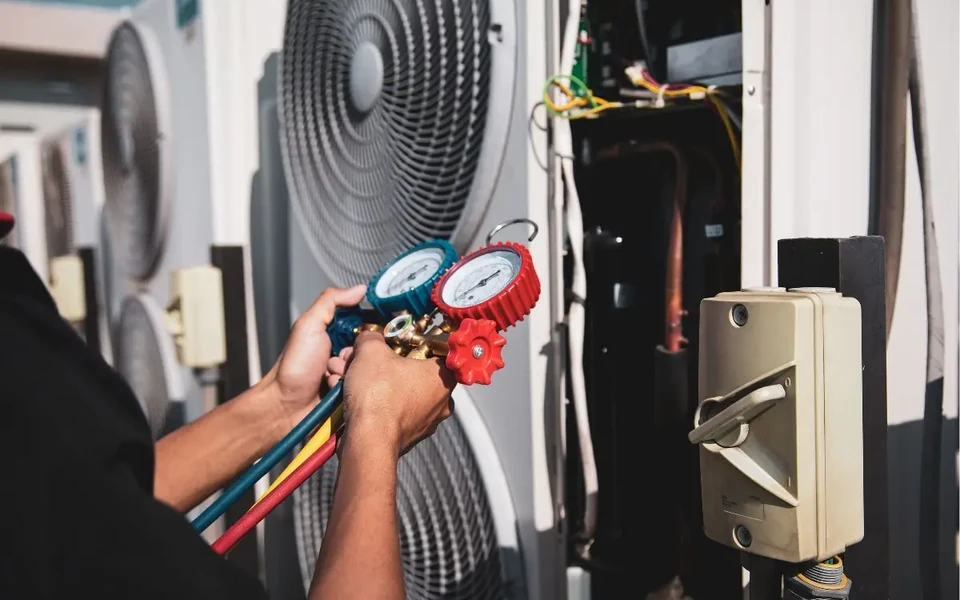 HVAC service gauges connected to outdoor equipment