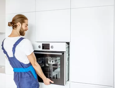 workman-installing-kitchen-oven-2022-01-19-00-00-18-utc
